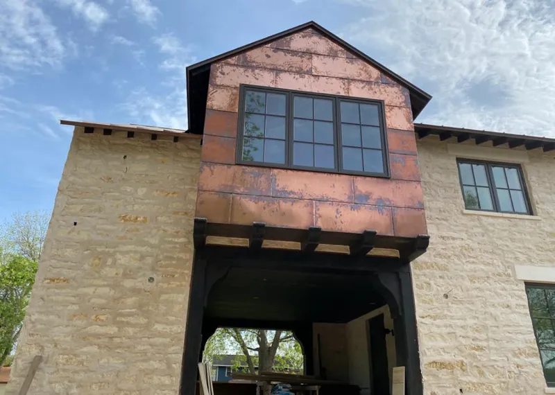 Copper metal panel facade on a stone building for Skylight Installation in Butner