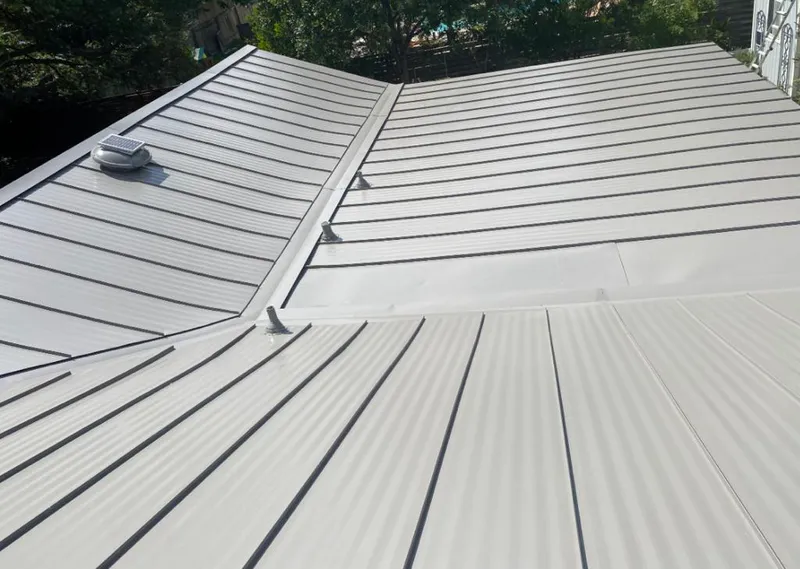 Solar attic fan installed on a metal roof for Roof Ventilation in Butner